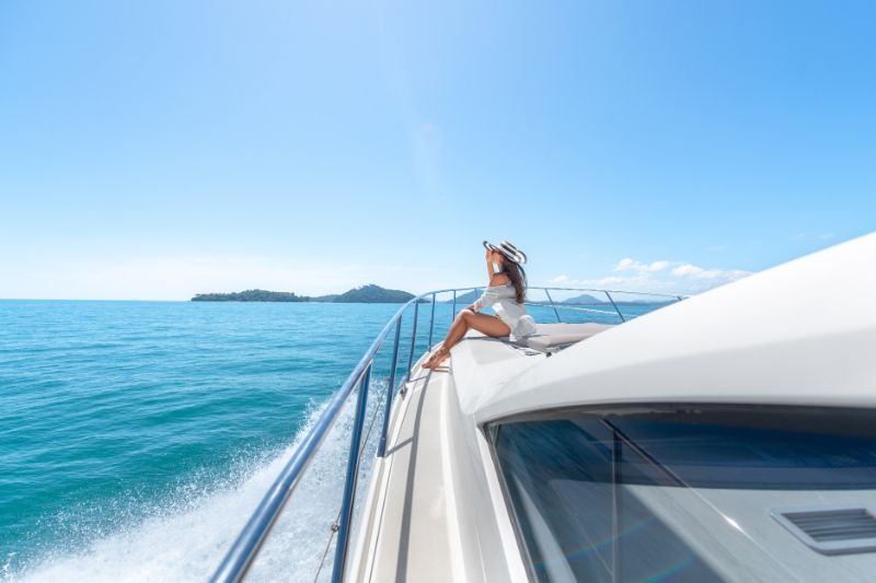 woman sat on luxury yacht insurance